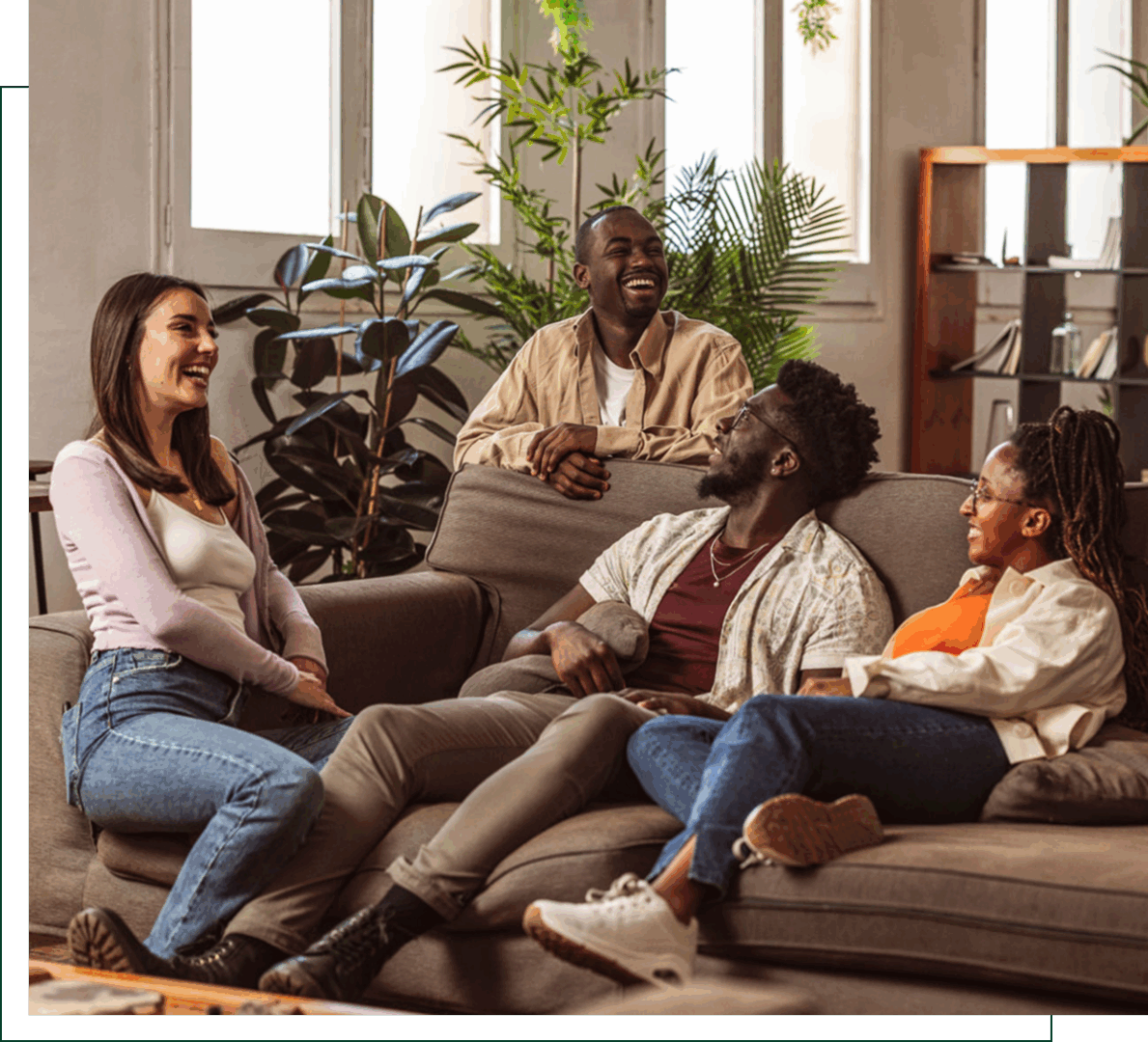 Group of friends laughing on a couch.