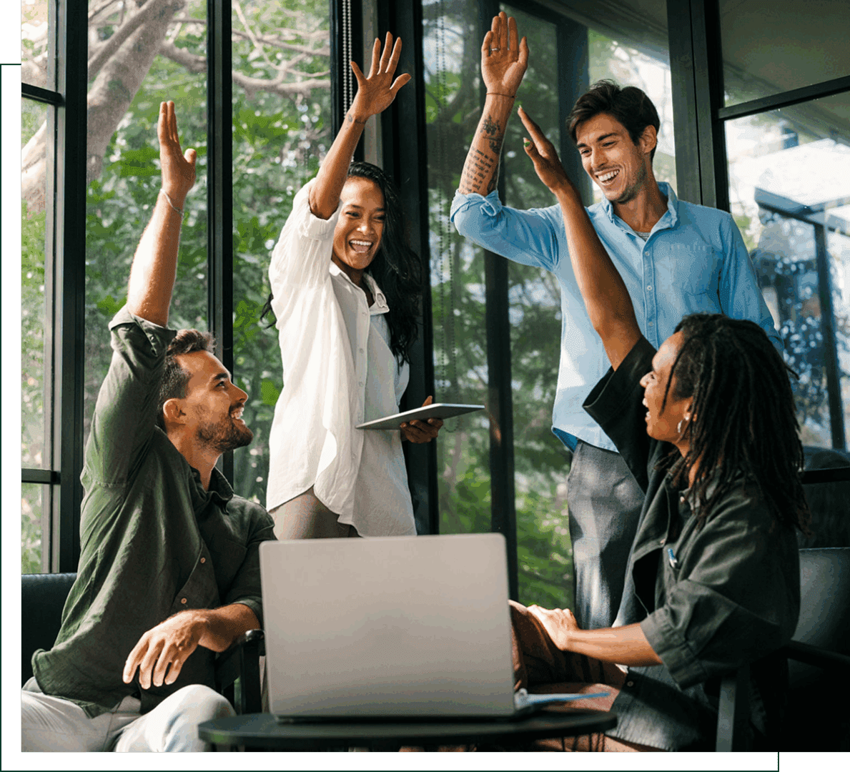 Team celebrating with high-fives in office.
