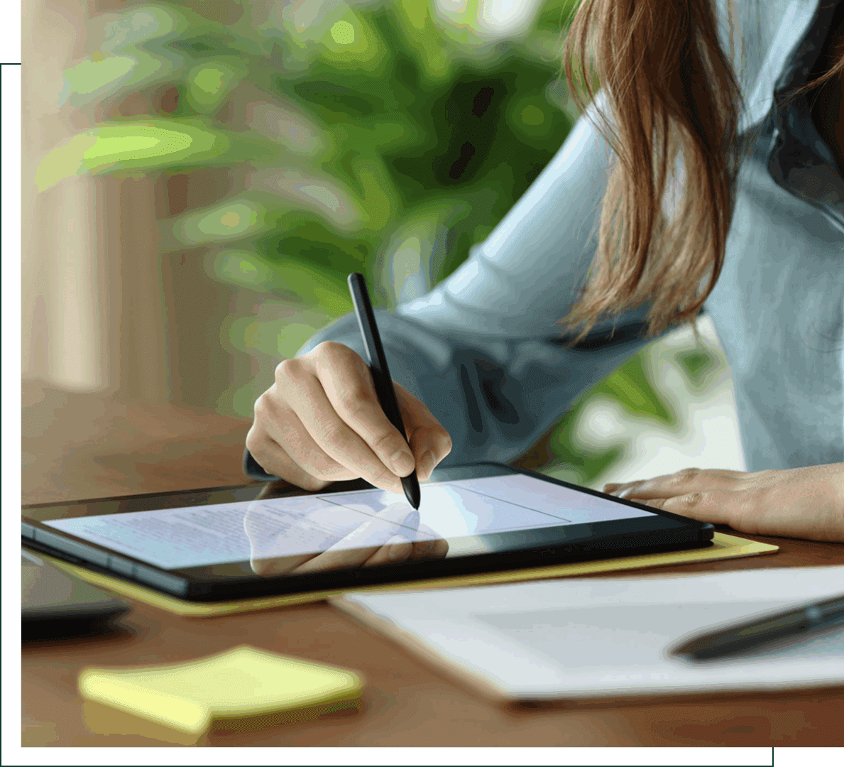 Person writing on tablet with stylus pen.